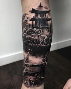 a person with a tattoo on their leg that is covered in black and grey ink