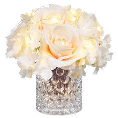 a vase filled with lots of white flowers