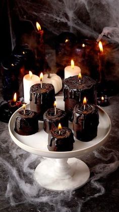 a white plate topped with chocolate cakes covered in candles