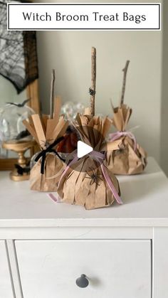 some brown paper bags sitting on top of a white dresser