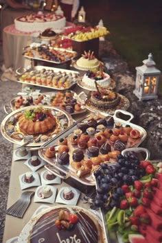 a table filled with lots of different types of desserts and pastries on it