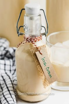 a glass jar filled with white liquid next to a cup