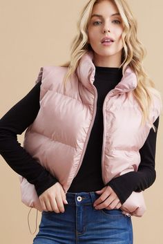 Stay warm and stylish with our Pearl Pink Puffer Vest! This solid vest features a zipper closure, turtle neck, and drawstring hemline for a flattering fit. Made of 100% polyester, it is lightweight and non-sheer. Perfect for layering and staying cozy. Model is 5'8" and wearing a Small. Trendy Solid Color Cold Weather Vest, Trendy Winter Vest With Zipper Closure, Trendy Solid Vest For Cold Weather, Casual Winter Vest With Zipper Closure, Spring Nylon Puffer Vest, Spring Outdoor Puffer Vest, Winter Nylon Vest With Zipper Closure, Fall Layering Nylon Vest, Fall Nylon Vest For Layering