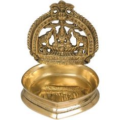 an ornately decorated brass plate with the image of lord ganesha on it