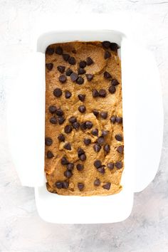 a loaf of chocolate chip bread in a white dish