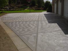 an empty driveway in front of a house