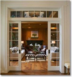 the living room is decorated in white and wood