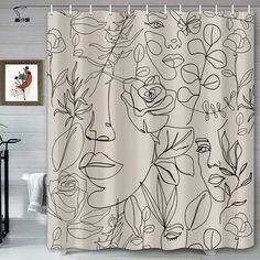 a shower curtain with black and white flowers on it