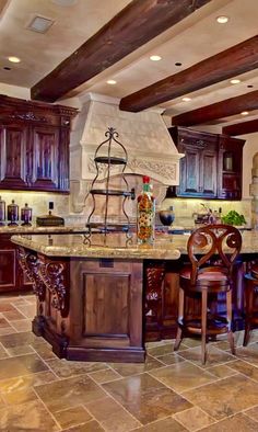 a large kitchen with wooden cabinets and an island in the middle of the flooring