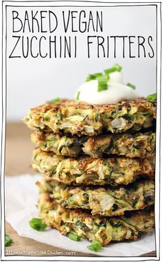 a stack of zucchini fritters with sour cream on top