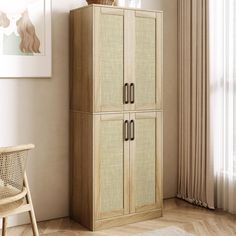 a tall wooden cabinet sitting in a living room next to a chair and painting on the wall