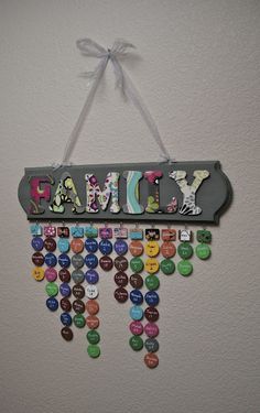 a sign hanging on the wall that says family with lots of buttons attached to it