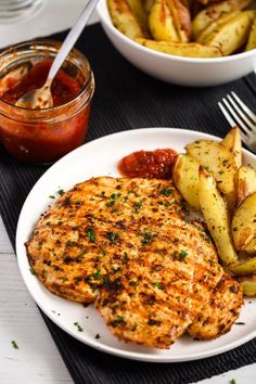 a white plate topped with chicken and potatoes