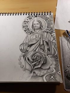 a drawing of jesus holding a rose on top of a table next to some pens and pencils