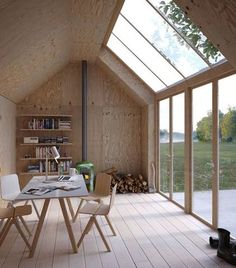 a room with wooden walls and flooring that has glass windows