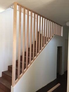 an empty room with wooden stairs and white walls