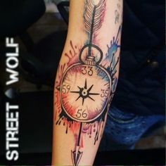 a tattoo with an arrow and clock on it