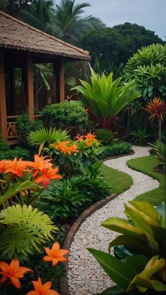 a garden with lots of plants and flowers on the ground, along with a small house