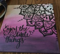 a painting with the words enjoy the little things written on it in black and purple