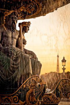 the statue is sitting under an umbrella in the rain