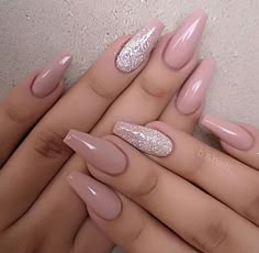 two hands with pink and white nail polishes on their nails, one is holding the other