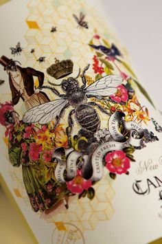 a close up of a card with flowers and bees on it