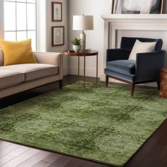 a living room filled with furniture and a green rug on top of a hard wood floor