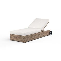 an outdoor chaise lounge chair with wheels on the back and seat cushion in wicker