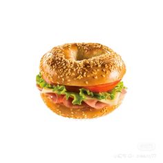 a bagel sandwich with ham, lettuce and tomato