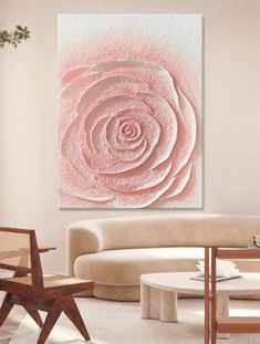 a living room filled with furniture and a large pink rose painting on the wall above it