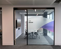 an office with glass walls and chairs