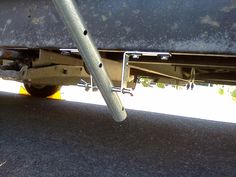 the bottom end of a vehicle with metal bars attached to it's rear bumper