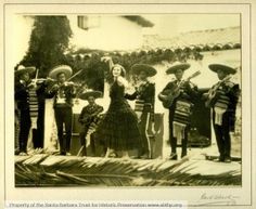 an old black and white photo of people dressed in mexican gaucho attire with instruments