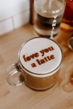 a cappuccino with the words love you latte written in brown on it