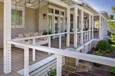 the front porch of a house with white railings