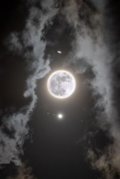 an image of the moon and two planets in the night sky with clouds around it