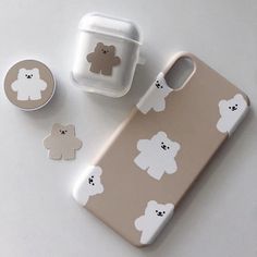 an iphone case with bears on it next to a cup and saucer in the shape of a teddy bear