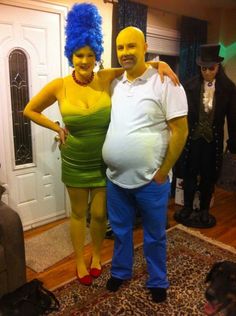 a man and woman dressed in costumes pose for a photo