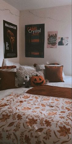 a bed room with a neatly made bed and posters on the wall