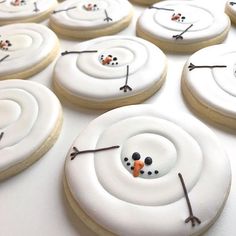 some cookies with frosting and icing are arranged in the shape of a snowman