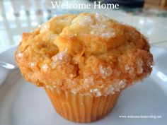 a close up of a muffin on a plate with the words welcome home above it