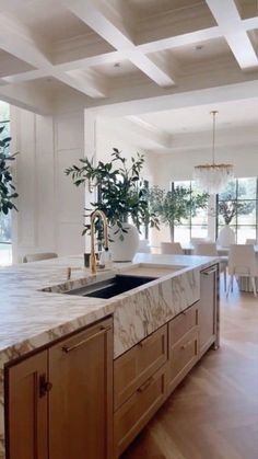 a large kitchen with marble counter tops and wooden cabinets, along with an island in the middle