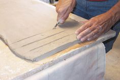 a man is cutting paper with a knife