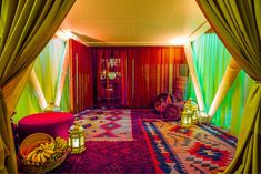 the room is decorated in bright colors and has colorful lights on the ceiling, along with an area rug