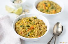 two white bowls filled with food next to a spoon