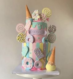 a colorful birthday cake decorated with candy and lollipops