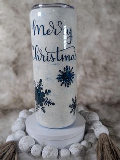 a white and blue christmas tumbler sitting on top of a table