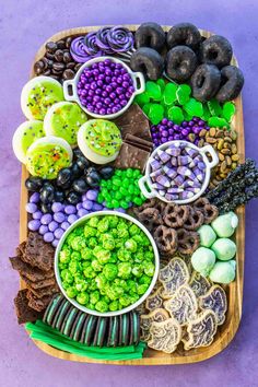 a platter filled with different types of food on top of a purple tablecloth