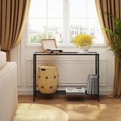 a living room scene with focus on the sofa and table in front of the window