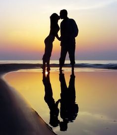 a man and woman kissing on the beach at sunset with a quote written below them